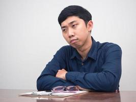 Asian man feels sadness about lay off employee sit at working table photo