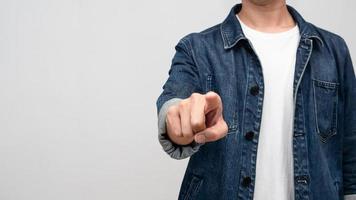 Close up man jeans shirt point finger at you isolated photo