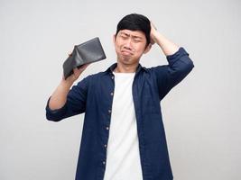 Asian man feels headache about no money in his wallet photo