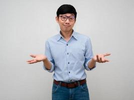 Handsome asian businessman show hands up confused i don't know isolated photo