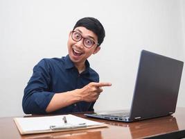 Businessman point finger at his laptop feels amazed photo