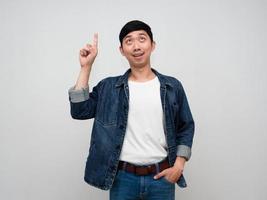 Handsome asian man jeans shirt standing point finger up isolated photo