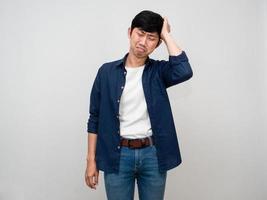 Depressed asian man feels sad gesture hold his head isolated photo