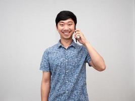 Positive asian man happy smile talking with cellphone isolated photo