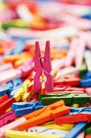 Colorful wooden clothespins close-up as a texture and background in full screen. photo