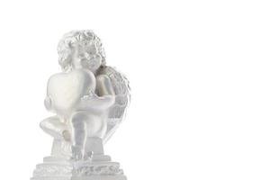 Cherub statue isolated on white background. Angel holds the heart. Love photo