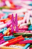 Colorful wooden clothespins close-up as a texture and background in full screen. photo