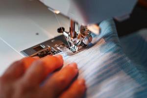 Sewing clothes on a sewing machine close-up. photo