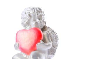 Cherub statue isolated on white background. Angel holds the heart. Love photo