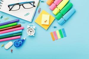 Office supplies lie on a blue background. To study in school. Rainbow color. photo