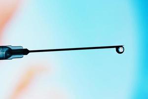 A human embryo on the tip of a needle in blue. illustrative editorial photo