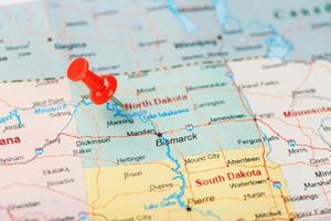 Red clerical needle on a map of USA, North Dakota and the capital Bismarck. Closeup Map North Dakota with Red Tack. United States photo