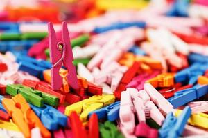 Colorful wooden clothespins close-up as a texture and background in full screen. photo