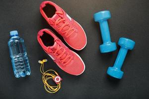 Top view of sportswear, dumbbells and digital devices isolated on grey photo