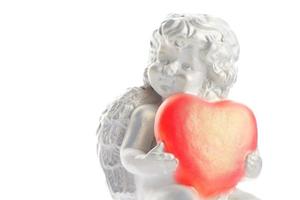 Cherub statue isolated on white background. Angel holds the heart. Love photo