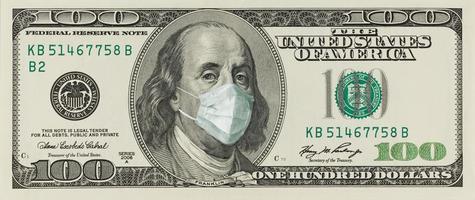 A 100-dollar bill with a face mask by Benjamin Franklin from the COVID-19 Coronavirus in the United States. photo