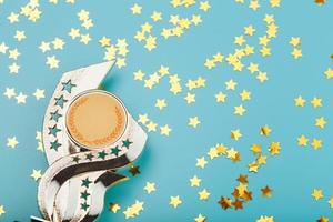 Gold trophy Cup with stars Celebrating success on a blue background. photo