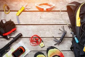 Set of things and tourist equipment for travel and adventure on a gray wooden background. Top view set photo