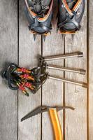 Top view of tourist equipment for a mountain trip on a rustic light wooden floor, sunlight photo