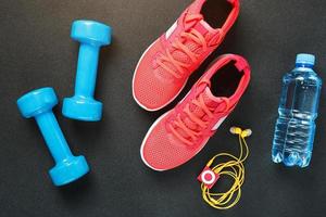 Set of sports accessories for fitness concept with exercise equipment on gray background photo