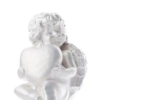 Cherub statue isolated on white background. Angel holds the heart. Love photo