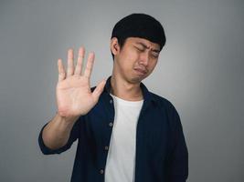 Asian man feels sad show hand up depressed hopeless photo