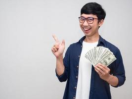 Cheerful businessman smile with holding money gesture point finger isolated photo