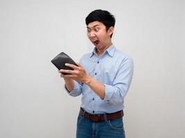 Asian businessman blue shirt feels sad and shocked face gesture find money at his wallet isolated photo