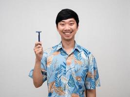 Portrait asian man holding shaving with happy smile isolated photo