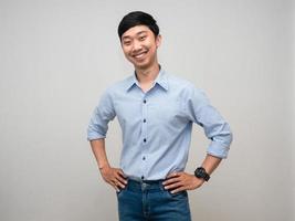 Positive man blue shirt stand at waist with happy smile photo