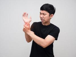 Asian man feels pain his wrist isolated photo