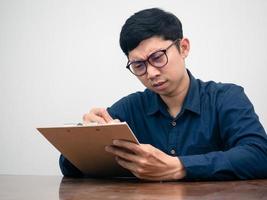 Man wear glasses serious about testing on table photo