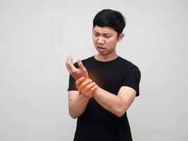 Young man feels pain his wrist isolated photo