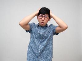 Male employee wear glasses feels unhappy gesture hold his head about headache from hard working isolated photo