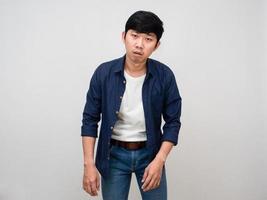 Asian man standing feels tried about hard working isolated photo