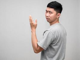 Portrait asian man grey shirt feels worried and  confused turn around to loking at you isolated photo