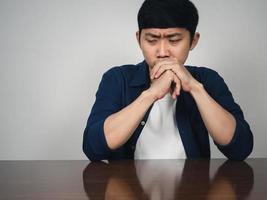 Sadness asian man sit at table depressed emotion photo