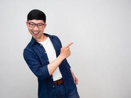 Positive asian man wear glasses gesture point finger isolated photo