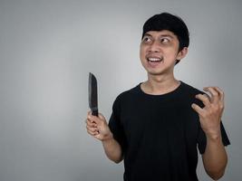 Horror man murder holding knife looking at copy space photo