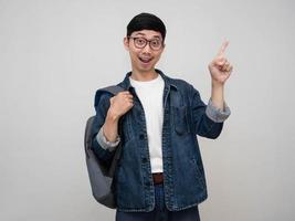 Portrait man jeans shirt wear glasses cheerful gesture point finger isolated photo