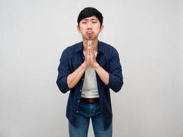 Asian man standing gesture respect hand need for apologize isolated photo