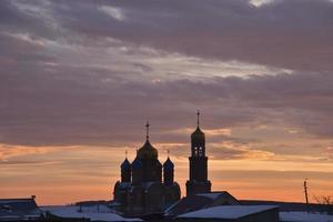 Orthodox church on the background of a beautiful red sunset. Landscape of a Christian church in the evening. photo