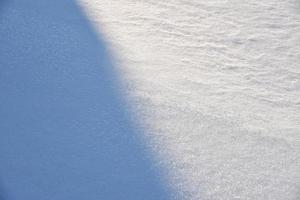 Snowy surface. White snow and snowdrifts in winter. photo