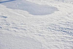 Snowy surface. White snow and snowdrifts in winter. photo