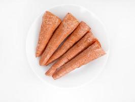 Peeled fresh carrots on a white background. Delicious fresh carrots. Fresh vegetables on the table. photo