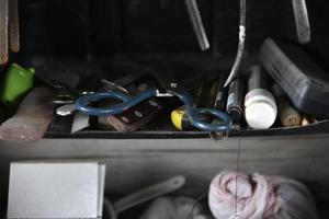 Old tools in a dusty shed. Tools in the garage on the shelf. photo