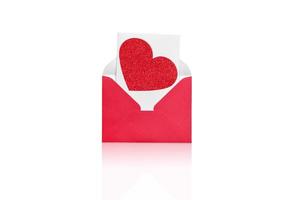 Red open envelope with a white sheet and red hear on a white background. photo