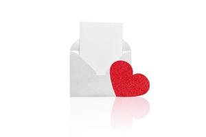 White open envelope with a white sheet and red hear on a white background. photo