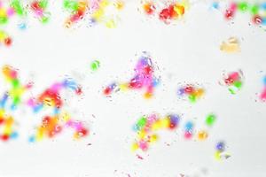 Multicolored bright abstract background. Blurry balls are visible through the spray on the glass. Spring colors photo