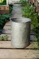 iron bucket with water in the country in the summer